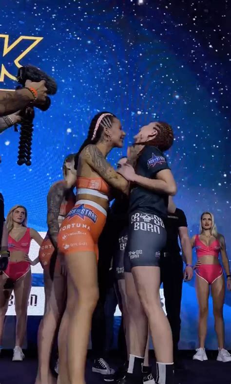 Crowd left stunned after two MMA fighters kiss during。